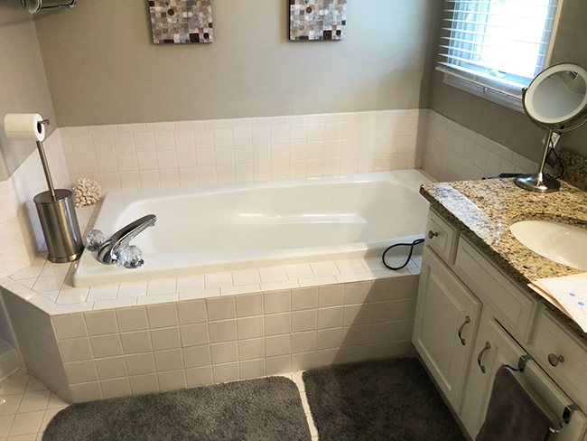 A before photo showing the bathtub and tub deck in a location where we would later put in a walk in shower.