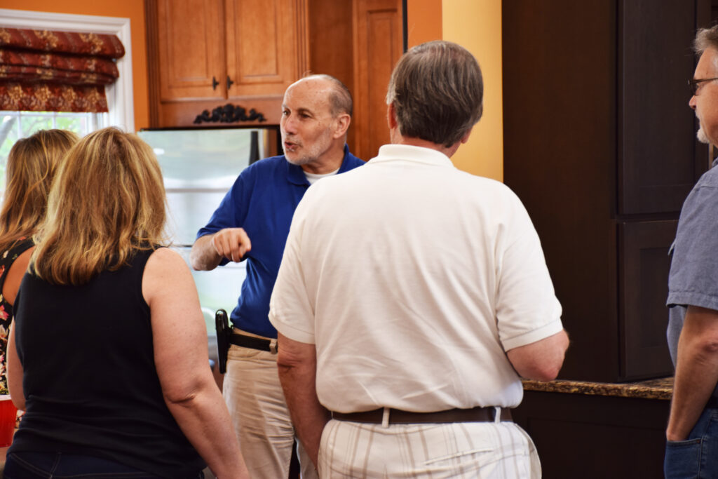 remodeler explaining proven process to showroom visitors